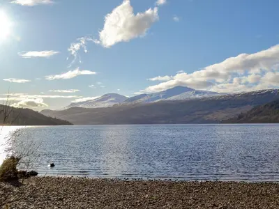 a view of a lake with mountains in the background at Anemone in Kenmore