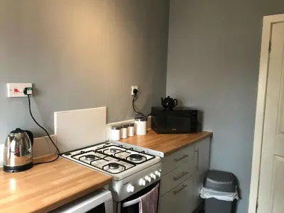 a kitchen with a stove and a microwave at Signature - Anderson View in Motherwell
