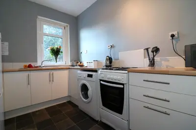 a kitchen with a stove and a dishwasher at Signature - Anderson View in Motherwell