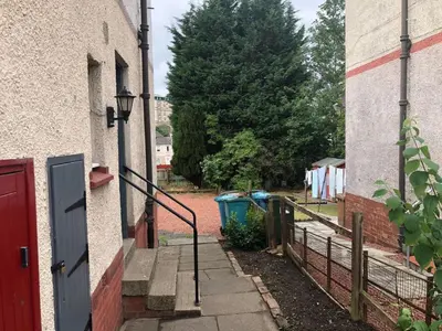 an entrance to a building with a red door at Signature - Anderson View in Motherwell