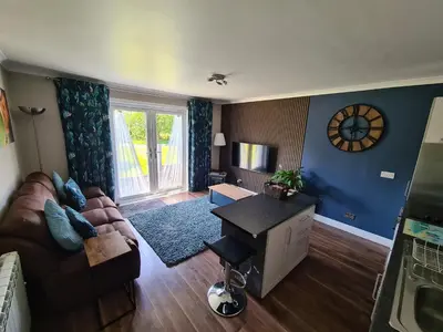 a living room with a couch and a table at Coel Ila in Benderloch