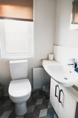 a bathroom with a toilet and a sink at Atlas Ovation Lodge in Auchterarder