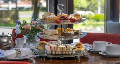 a three tiered tray of pastries on a table at Best Western The Hilcroft Hotel West Lothian in Whitburn