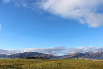 a view of the ocean and mountains in the distance at Lurach House in Port Appin