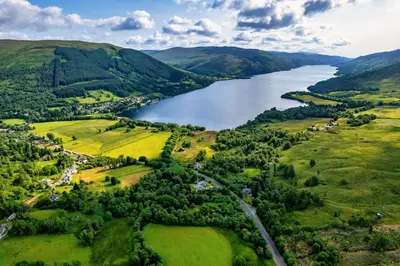an aerial view of a lake in the hills at Mansewood Country House in Lochearnhead