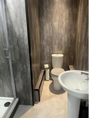 a bathroom with a toilet and a sink at Balmaha Lodges and Apartments in Balmaha