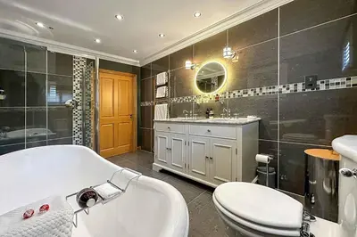 a bathroom with a tub and a toilet and a sink at Outlander Glencoe at Creag an-t Sionnaich Glencoe Ballachulish Highlands Near Fort William in Glencoe