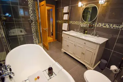 a bathroom with a tub and a toilet and a sink at Outlander Glencoe at Creag an-t Sionnaich Glencoe Ballachulish Highlands Near Fort William in Glencoe