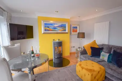 a living room with a couch and a glass table at Outlander Glencoe at Creag an-t Sionnaich Glencoe Ballachulish Highlands Near Fort William in Glencoe