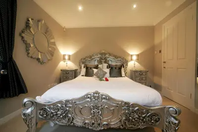 a bedroom with a bed with a silver bed frame at Ayrs and Graces - Luxury Bed and Breakfast in Ayr