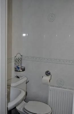 a small bathroom with a toilet and a sink at Abbotsford Hotel in Dumbarton