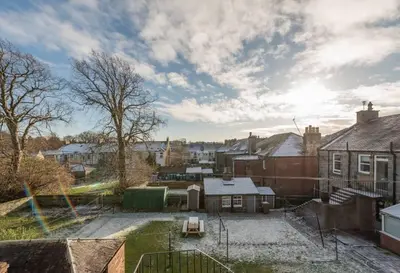 a view of a city with houses and a yard at Brucefield Avenue, Dunfermline in Dunfermline