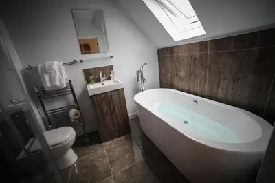 a bathroom with a white tub and a toilet at Bay and Bridge near Edinburgh in Dunfermline