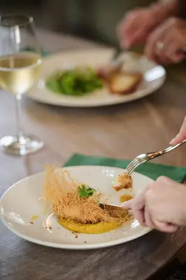 a person eating a plate of food on a table at Cairn Lodge in Auchterarder