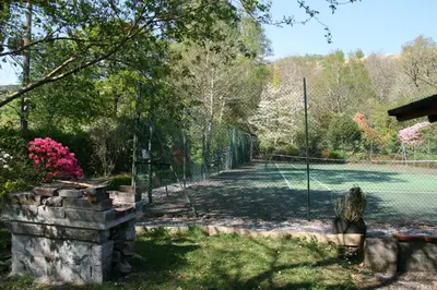 a tennis court with a fence and a tennis court at Laich Cottage in Appin
