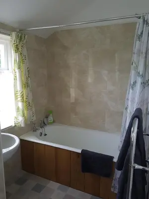 a bathroom with a bath tub and a sink at Laich Cottage in Appin