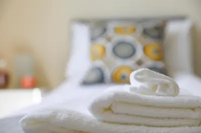 a pile of white towels sitting on a table at Netherton House in Wishaw