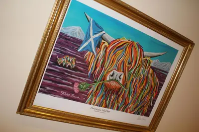 a framed painting of a lion with a star at Nelson Seaside Apartment in Largs
