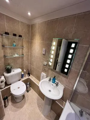 a bathroom with a sink and a toilet and a mirror at Gleneagles Lettings in Auchterarder