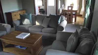 a living room with a couch and a coffee table at Craobh Marina Cottages in Craobh Haven