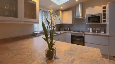 a kitchen with a vase with a plant on a counter at Balloch Park in Aberfeldy