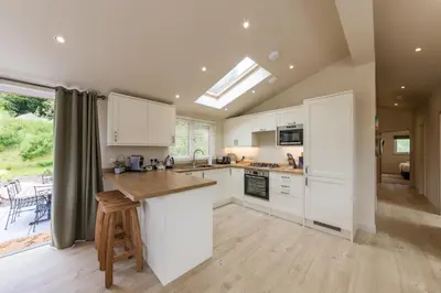 a kitchen with white cabinets and a counter top at Balloch Park in Aberfeldy
