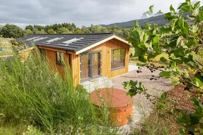 a tiny house with solar panels on the roof at Balloch Park in Aberfeldy
