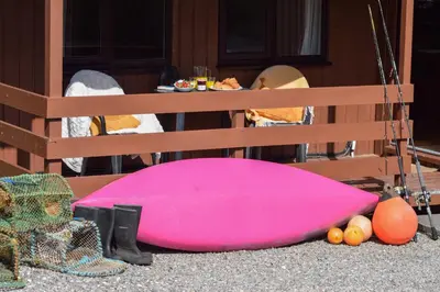 a pink pillow sitting on the ground next to a table at Birchbrae Highland Lodges in Onich