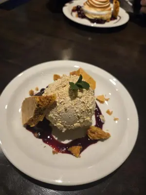 a white plate with a dessert on a table at The Old Schoolhouse Hotel in Larkhall