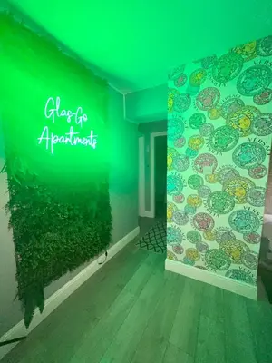a neon sign on a wall in a room at 2 Bedroom Apartment at SECC Hydro FREE PARKING in Glasgow