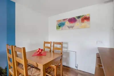 a dining room table with two chairs and a plate on it at Wallace's Rest in Stirling
