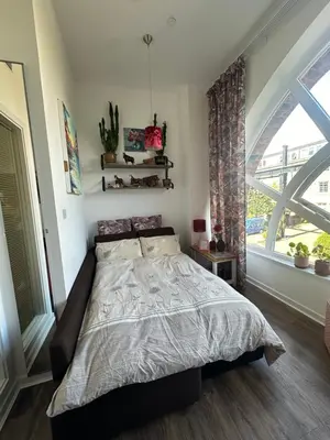 a bedroom with a bed and a large window at Stunning 2 bedroom apartment in Glasgow