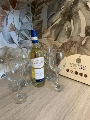 a bottle of wine and three wine glasses on a table at Stunning 2 bedroom apartment in Glasgow