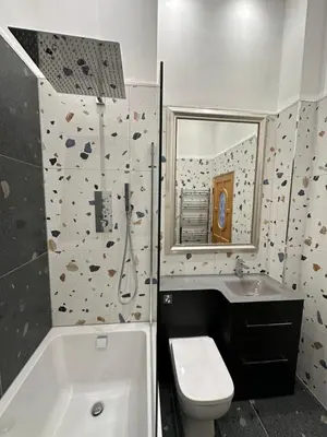 a bathroom with a sink and a toilet and a tub at Stunning 2 bedroom apartment in Glasgow