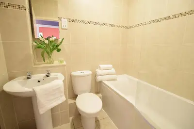 a bathroom with a toilet and a sink and a tub at JOIVY Bohemian Writers Retreat in Old Town in Edinburgh