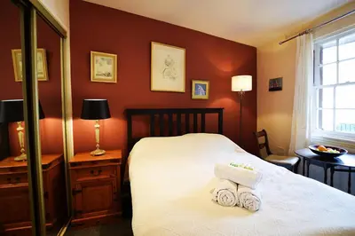 a bedroom with a bed with two towels on it at JOIVY Bohemian Writers Retreat in Old Town in Edinburgh