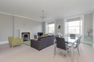 a living room with a couch and a table at Destiny Scotland - Q-Residence in Edinburgh