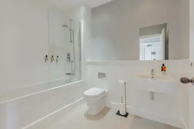a white bathroom with a toilet and a sink at Destiny Scotland - Q-Residence in Edinburgh