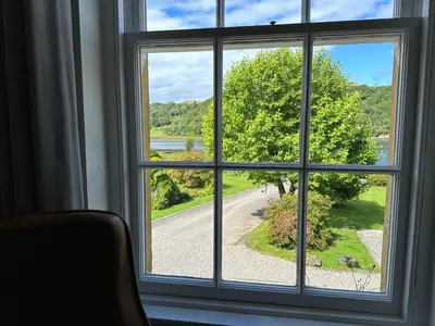 a window with a view of a road at Knipoch House Hotel in Oban