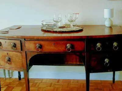 a wooden table with glasses on top of it at Tobar nan Iasgair Lismore in Achnacroish
