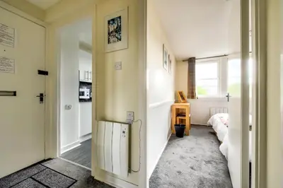 a hallway with a door leading to a bedroom at Charming 1 Bed Apartment with Castle View in Edinburgh