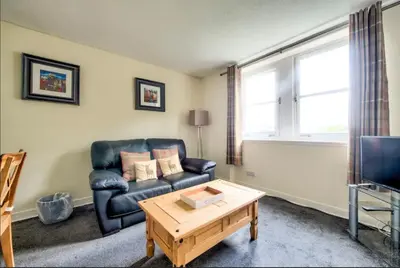 a living room with a couch and a coffee table at Charming 1 Bed Apartment with Castle View in Edinburgh