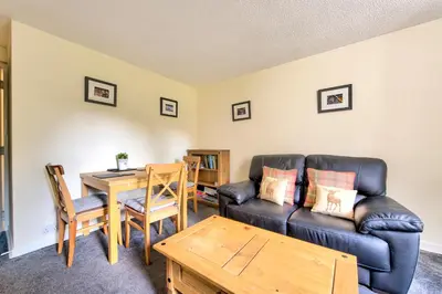 a living room with a couch and a table at Charming 1 Bed Apartment with Castle View in Edinburgh