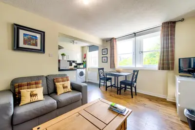 a living room with a couch and a table at Stunning Studio Apartment Castle View in Edinburgh