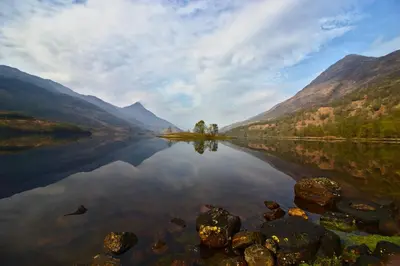 a view of a lake in the middle of a valley at Nevis Pod, West Highland Way Holidays in Kinlochleven