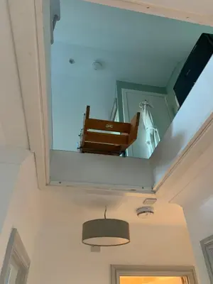 a mirror on the ceiling of a room with a bench at The Grey Cottage in Blackford