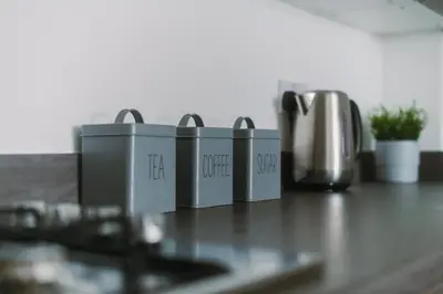 a counter top with four appliances on a table at ComfySleep Apartments in Glasgow