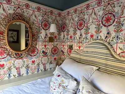 a bedroom with a bed and a mirror at Neidpath Castle Cottage in Peebles