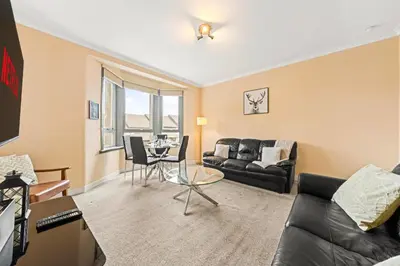 a living room with a couch and a table at Three Bed Holiday Home in Glasgow in Glasgow