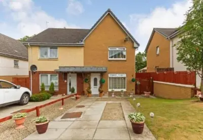a house with a car parked in front of it at Silverburn new house with free parking and nice garden in Glasgow
